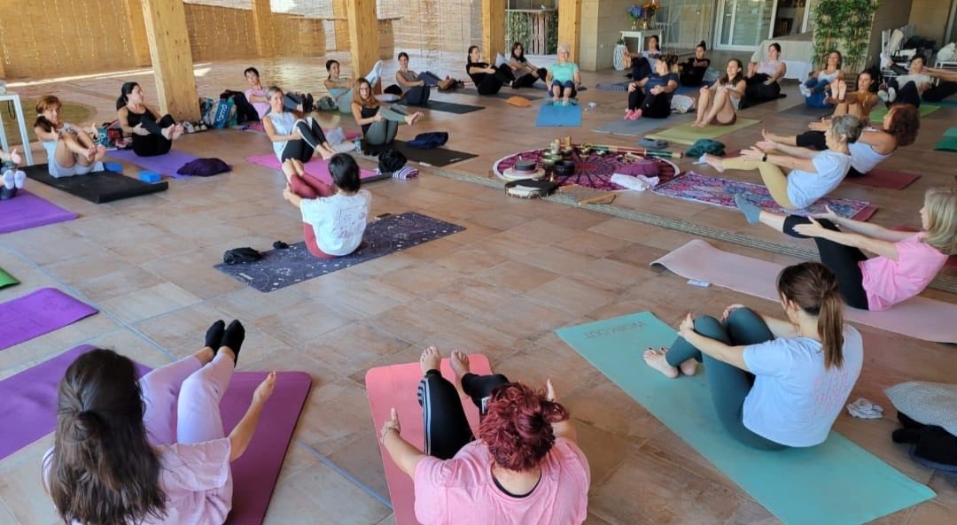 People sitting in a circle doing yoga.